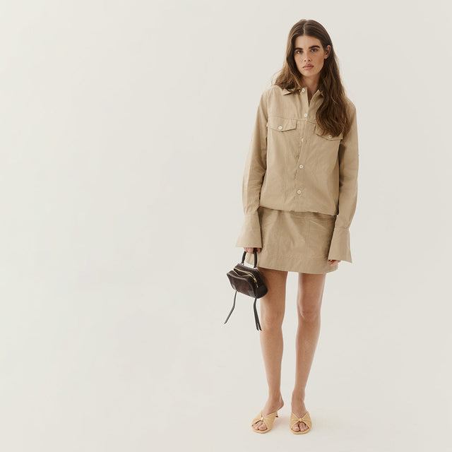 woman wearing khaki Loewe dress holding loewe amazona 180 handbag