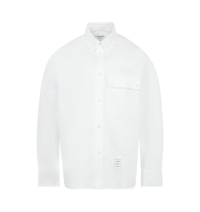 Image 1 of 2 - WHITE - THOM BROWNE Opique Oversized Shirt featuring cotton piqu, classic silhouette with subtle texture and shape, self-fabric armbands, front button closure, oversized fit, point collar, patch chest pocket with buttoned flap, button-fastening self armbands, buttoned cuffs, pleated back yoke with locker loop, curved stepped hem, name tag appliqu and signature striped grosgrain loop tab. 100% cotton. Made in Italy.