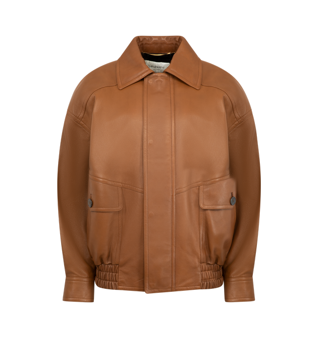 Image 1 of 4 - BROWN - SAINT LAURENT Bomber Jacket in lambskin featuring drop shoulders, a shirred waist, cotton and viscose lining, zip closure with snap-button storm flap, two patch pockets with button flat and two jetted pockets at the front, one inner welt pocket, pointed collar, one-button cuffs and padded shoulders. 100% lambskin. Made in Italy.