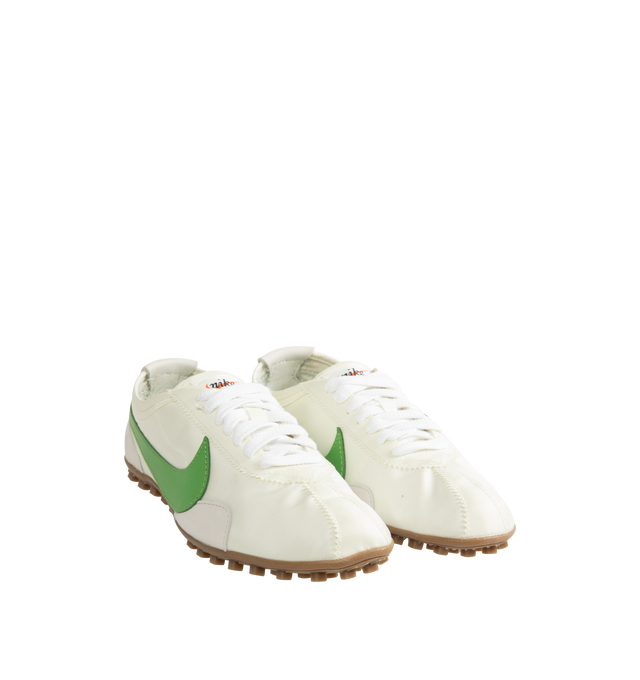 Image 2 of 5 - GREEN - Nike Men's Moon Shoe OG SP Sneakers feature a Sail, Light Bone, and Chlorophyll nylon upper with a leather Swoosh. Inspired by Nike's original 1970s running shoe, the streamlined silhouette is set on a rubber Waffle outsole for durable traction. Upper: Nylon and Leather. Sole: Rubber.