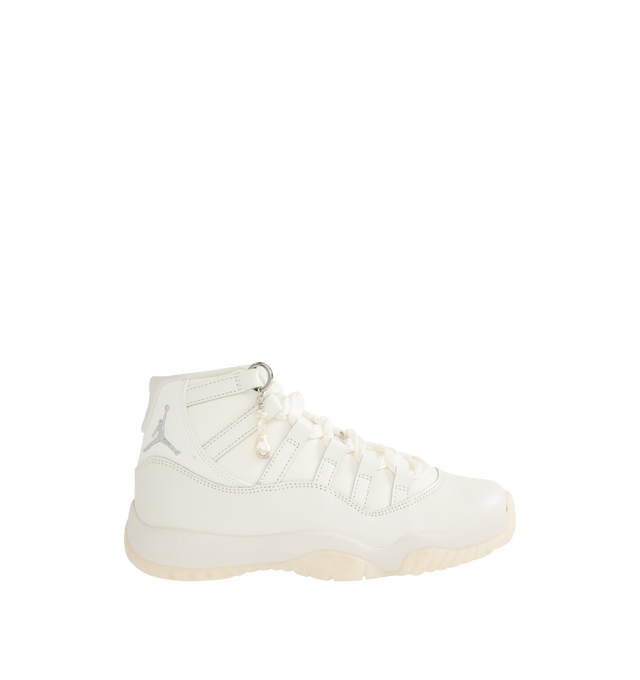 Image 1 of 5 - WHITE - JORDAN Air Jordan 11 Retro Sneaker featuring patent leather upper, lace-up front, foam midsole, Air cushioning, rounded toe, pearl charm and rubber outsole.
