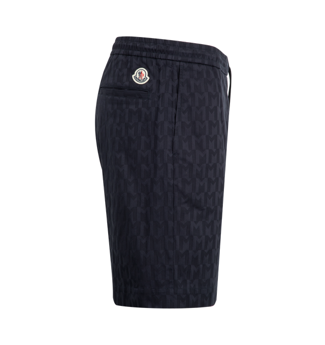 Image 3 of 3 - NAVY - Moncler Monogram Printed Shorts have an elastic drawstring waist, side pockets, and a back button flap pocket. 100% polyester. Made in Italy