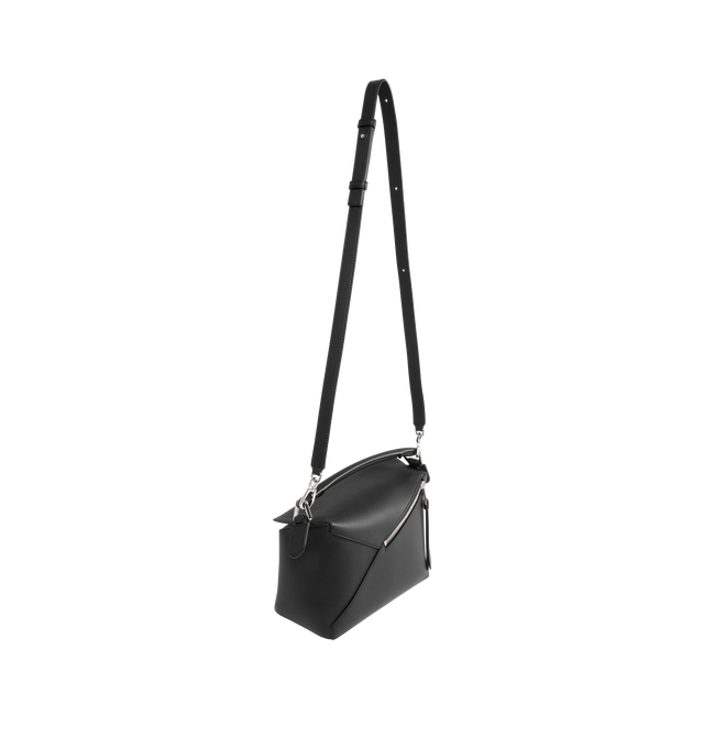 Image 2 of 3 - BLACK - LOEWE Small Puzzle Edge Bag in calfskin featuring geometric lines, cuboid form, overlapped panels with single stitch lines, shoulder, crossbody or hand carry, detachable and adjustable strap, zip closure with calfskin pull, one external zip rear pocket, one internal slip pocket, herringbone cotton canvas lining and embossed Anagram. Soft grained calf. 16.5 cm x 24 cm x 10.5 cm. Made in Spain.