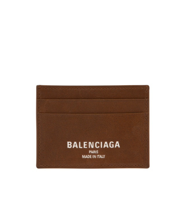 Image 1 of 3 - BROWN - Balenciaga Card Holder is crafted from smooth calfskin leather. Features four card slots, one bill pocket, and debossed Balenciaga Paris logo with silver foil at the front. Main Material: 100% Calf Leather. Made in Italy.