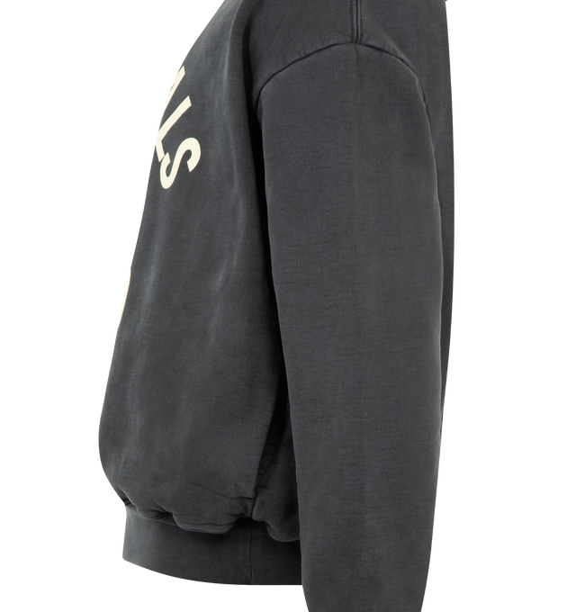 Image 3 of 3 - BLACK - FEAR OF GOD ESSENTIALS Campus 90s Hoodie 520GSM heavy fleece, pigment dyed, cropped, relaxed silhouette, exaggerated proportions with dropped shoulders for a relaxed drape, Essentials Fear of God campus puff-print graphic, side pockets, rib-knit cuffs, waist-hem and Fear of God Essentials label on the hood. 100% cotton.