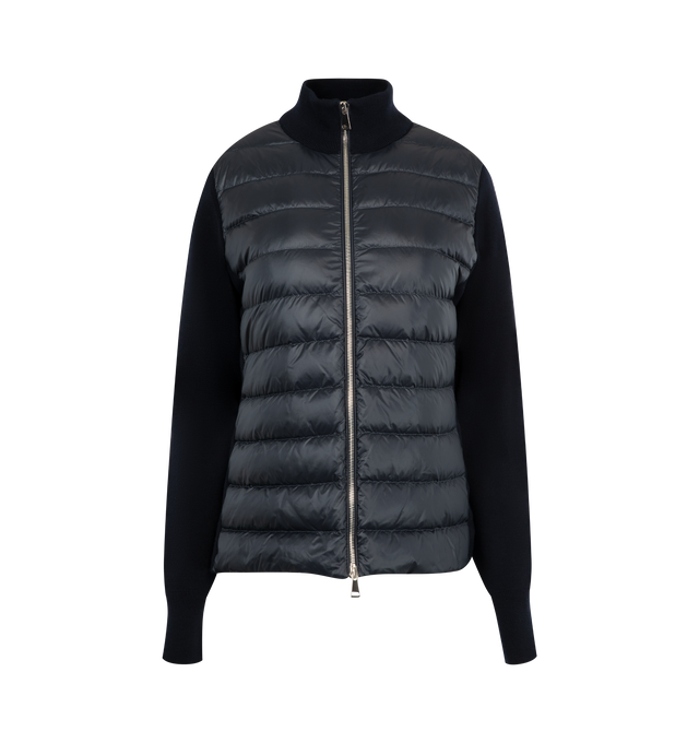 Image 1 of 3 - NAVY - MONCLER Padded Wool Zip-Up Cardigan featuring an attached drawstring hood, front zip closure, channel-quilted body, ribbed cuffs and hem, zip pockets, flap sleeve pocket, and logo patch detail. Lined body and hood. 100% polyamide/nylon. Padding: 90% down, 10% feather.