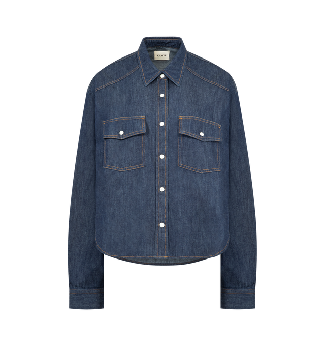 Image 1 of 2 - BLUE - KHAITE Grenon Shirt featuring a slouchy fit, cropped, western yoke, pearl snap closures, marigold topstitching, angle-flap patch pocket at chest and shirttail hem that dips lower in back. 100% organic cotton.