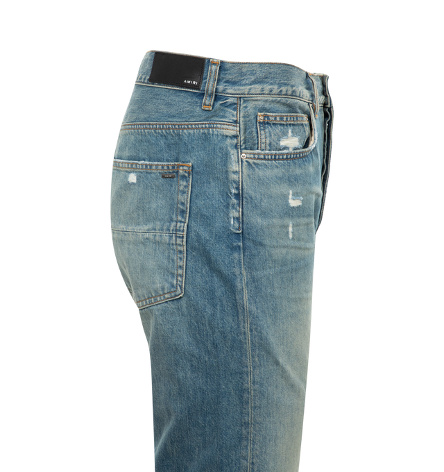 Image 2 of 2 - BLUE - AMIRI Release Hem Jeans featuring straight-leg, belt loops, five-pocket styling, button-fly, leather logo patch at back waistband, logo-engraved silver-tone hardware and contrast stitching in tan. 100% cotton. Made in United States.