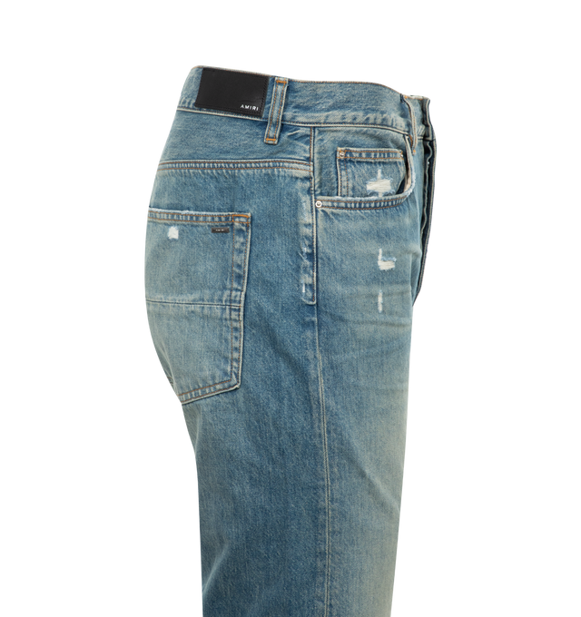 Image 2 of 2 - BLUE - AMIRI Release Hem Jeans featuring straight-leg, belt loops, five-pocket styling, button-fly, leather logo patch at back waistband, logo-engraved silver-tone hardware and contrast stitching in tan. 100% cotton. Made in United States. 