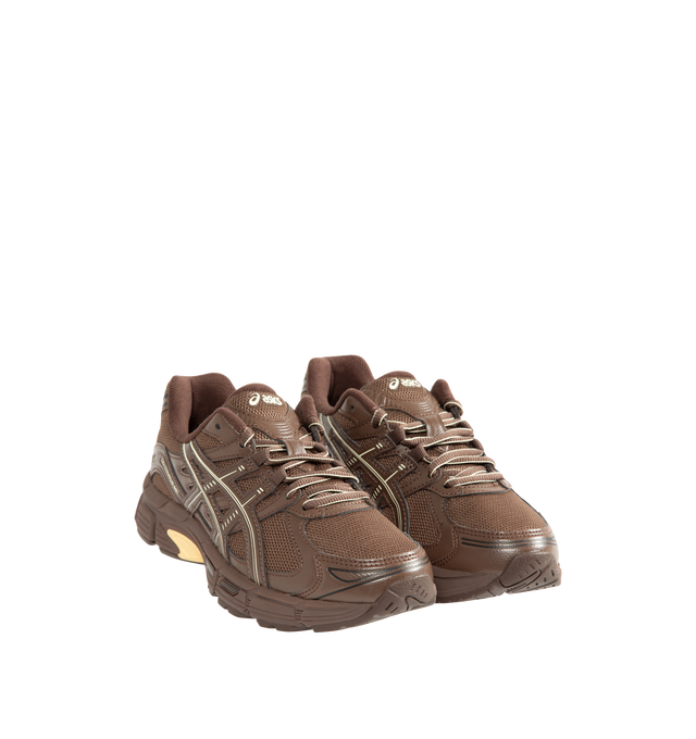Image 2 of 5 - BROWN - Asics Unisex Emmi x Gel-Stratus MC Sneakers are crafted with synthetic leather overlays and breathable air mesh underlays and feature a streamlined silhouette inspired by technical running footwear. Designed in an exclusive Brown Storm colorway, this collaborative style is equipped with rearfoot GEL technology and GEL-JOG MC-inspired tooling for enhanced cushioning and everyday comfort. Main Material: Synthetic Leather and Mesh. Cushioning: Rearfoot GEL Technology.
