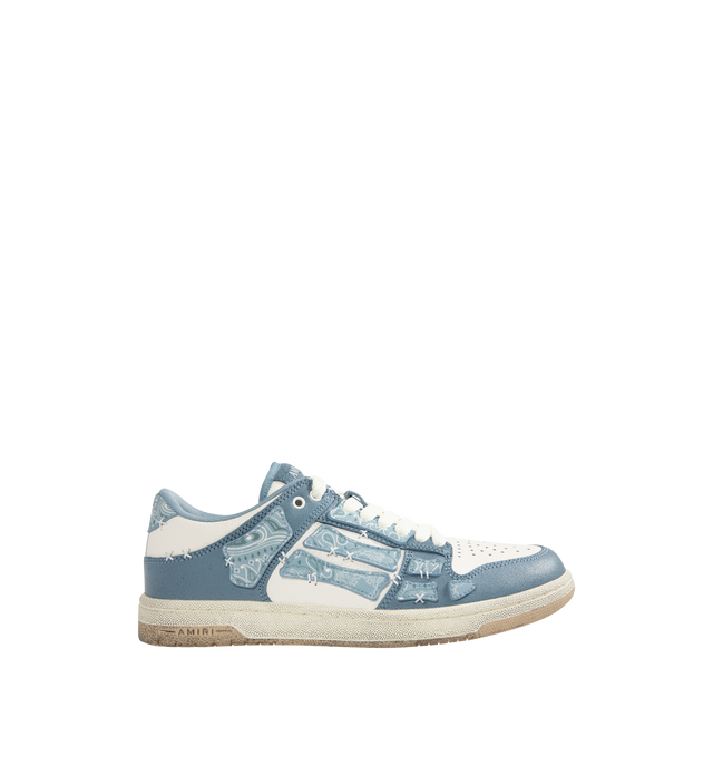 Image 2 of 5 - BLUE - AMIRI Bandana Skel Top Low Sneakers featuring low-top, buffed leather, logo pattern embossed throughout, perforated detailing at toe, lace-up closure, logo patch at padded tongue, padded collar, bandana print appliqus at sides and treaded rubber sole. Upper: leather. Sole: rubber.
