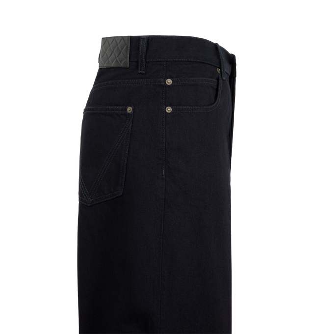 Image 3 of 3 - BLUE - Bottega Veneta Men's Trousers are crafted from dark indigo denim and feature a high-rise waist, a wide-leg silhouette, and an embossed Intrecciato leather patch at the back. Designed with a clean five-pocket-inspired construction and button closure, these jeans combine relaxed proportions with signature house detailing. Main Material: Cotton.