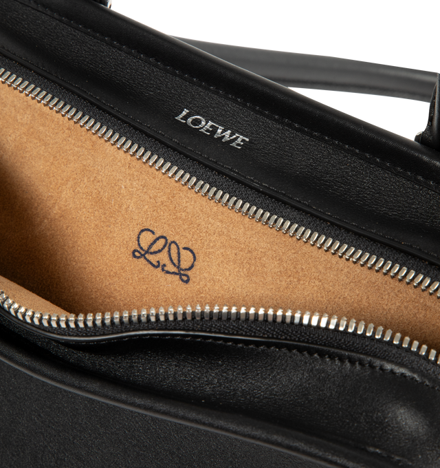 Image 5 of 5 - BLACK - Loewe Small Amazona 180 Bag in leather features a relaxed silhouette anchored by a single toron top handle, designed to be carried open, while a concealed closure secures the main compartment, three carry options: short handle, removable shoulder strap and crossbody, zip closure with two leather zip pullers, two compartments, main compartment closed with magnetic closure, internal flat pocket, left side d-ring for customization, nappa lambskin lining, and embossed double L branding. L