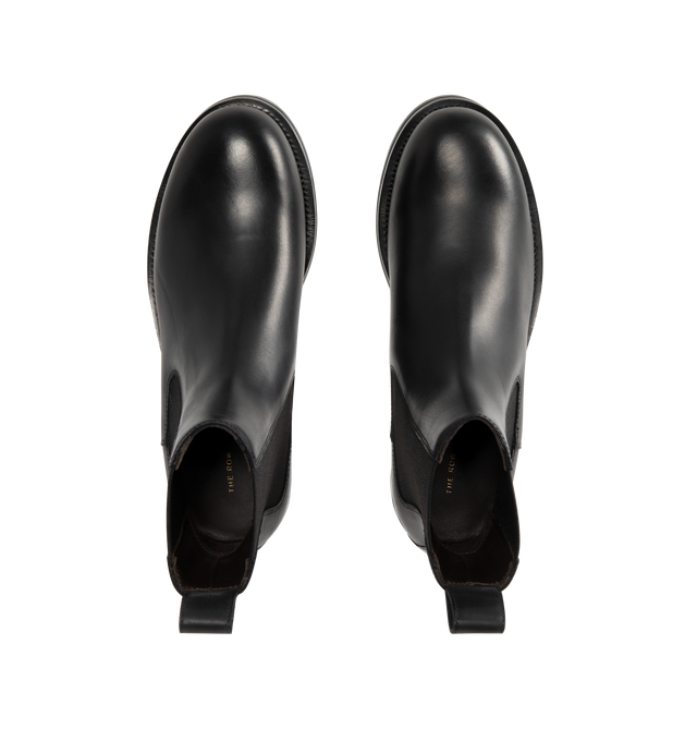 Image 4 of 4 - BLACK - THE ROW Chelsea Lug Sole Boots featuring round toe, pull-on style, branded leather insole, chunky rubber lug sole, ankle-length and elastic side panel. 100% calfskin leather. Sole: 100% rubber. Made in Italy.