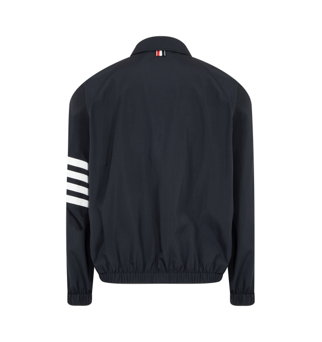 Image 2 of 3 - NAVY - THOM BROWNE Ripstop Raglan Coach Jacker featuring front two-way zip closure, raglan sleeves, welt hand pockets, one interior pocket, elasticated cuffs and hem, engineered 4-bar detailing and signature striped grosgrain loop tab. 81% polyamide, 19% polyester. Made in Italy.