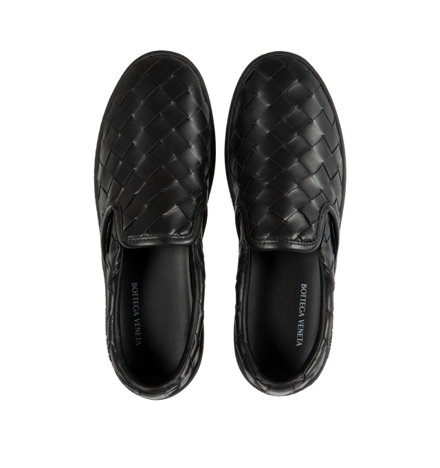 Image 5 of 5 - BLACK - BOTTEGA VENETA Sawyer Slip-On Sneakers featuring padded collar, elasticized gusset at sides, logo flag at outer side, logo printed at padded footbed, logo embossed at textured rubber midsole and treaded rubber sole. Upper: leather. Sole: rubber. Made in Italy. 