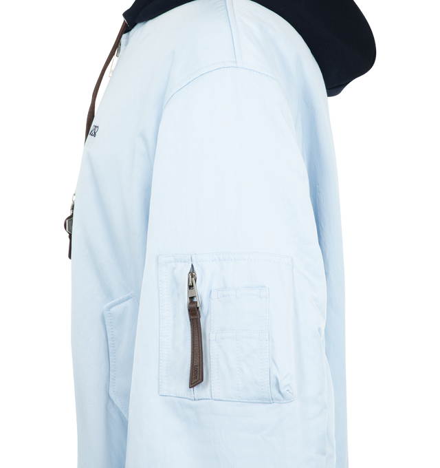 Image 3 of 3 - BLUE - Loewe Men's Bomber Jacket in Technical Shell is crafted from lightweight technical shell and features a regular-fit silhouette with a contrasting fleece hood. Designed with a zip-front closure, leather drawstring with detachable Anagram key ring detail, snap flap pockets, a sleeve zip pocket, interior welt pockets, ribbed cuffs and hem, and two-tone Anagram embroidery at the chest. Main Material: 100% Polyamide. Fully Lined. Made in Italy.