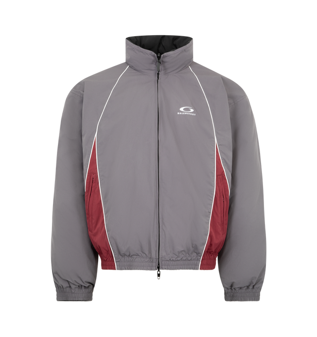 Image 1 of 4 - GREY - BALENCIAGA Reversible Tracksuit Jacket featuring cotton-like polyamide, reversible design: one smoky purple side with contrasting yokes, one plain black side, high neck, front zip closure, long sleeves, 2 zipped slash pockets on the smoky purple side, 2 snap slash pockets on the black side, elasticated cuffs and waistband and loop sports icon embroidered on chest on both side. 100% polyamide. 100% polyester. Filling: duck down. Made in Italy.