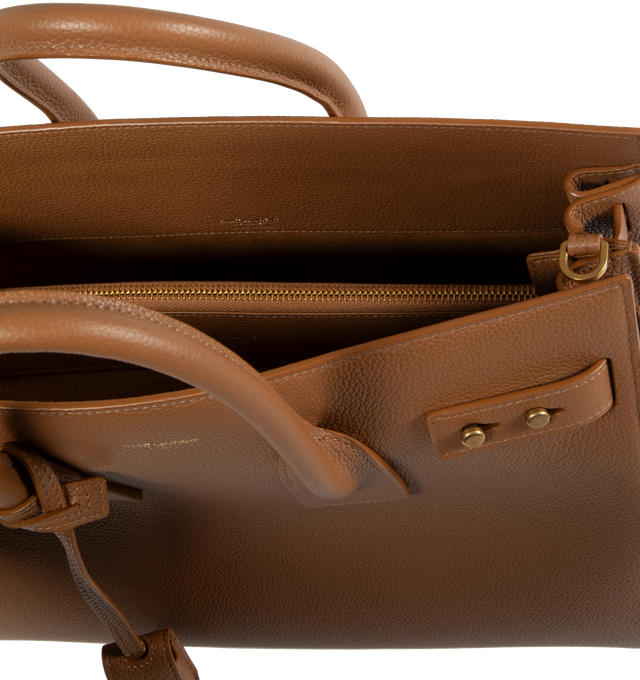 Image 3 of 3 - BROWN - SAINT LAURENT Sac De Jour Small in Supple Grained Leather featuring suede lining, accordion sides, detachable padlock in leather case, interior zipped pocket, five metal feet and detachable shoulder strap. 12.5 X 10 X 6.1 inches. 95% calfskin leather, 5% metal. Made in Italy.  