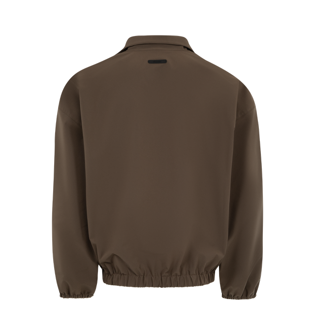 Image 2 of 3 - BROWN - FEAR OF GOD ESSENTIALS Active Trace Half Zip Track Jacket featuring perforated lining for breathability, detailed with an embroidered Essentials active trace logo on the sleeves, relaxed, rounded silhouette, high neck, half-zip front, elasticized cuffs and waist hem and Essentials signature label is at the back collar. 100% polyester.