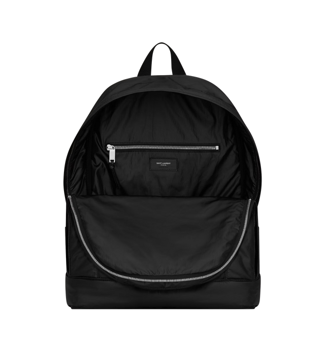Image 4 of 4 - BLACK - SAINT LAURENT City Backpack featuring a front zip pocket and double zip compartments, canvas lining, silver-tone hardware, two-way zip closure, two main zip compartments, one zip pocket, one front zip pocket and adjustable padded straps. 12.6" x 16.5" x 5.5". Polyamide, brass. Made in Italy.