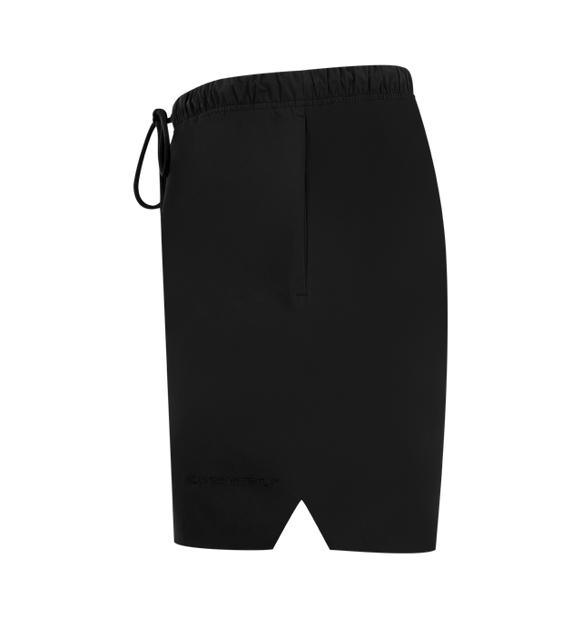Image 3 of 3 - BLACK - FEAR OF GOD ESSENTIALS Active Trace Relaxed Short featuring a perforated lining for enhanced breathability, a voluminous, elongated silhouette, 3M Embroidered Essentials Active Trace logo divided across both legs, Essentials signature label is positioned at the center front, side pockets, leg slits and an encased elastic waistband with drawstrings. 100% polyester.