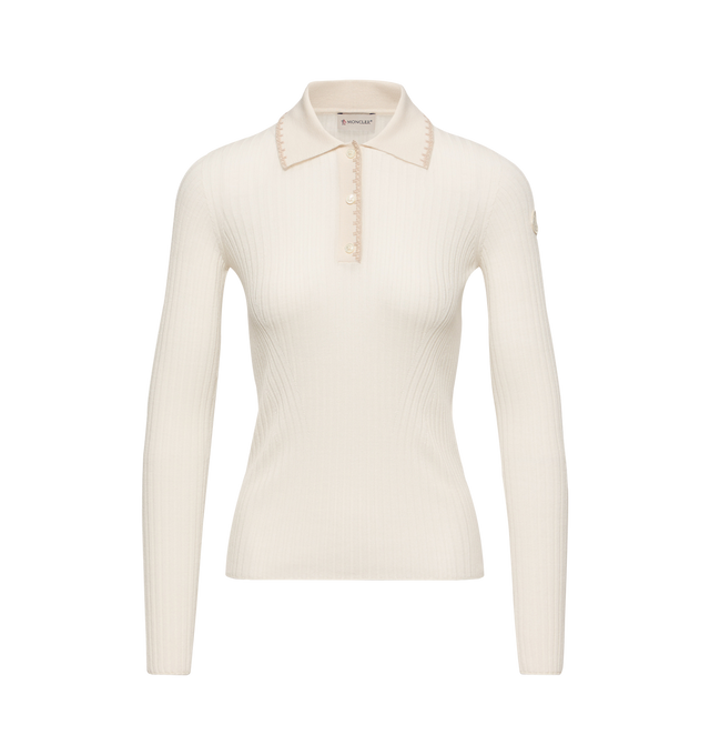 Image 1 of 1 - NEUTRAL - Moncler Womens Merino Wool Polo Sweater is crafted from lightweight merino wool and features a fine gauge 18 knit, classic collar, button-front closure, long sleeves, embroidered trim, and a signature leather logo patch. This designer wool polo sweater combines timeless knitwear with a refined silhouette for elevated everyday layering. Main Material: 100% Virgin Wool. Made in Romania.
