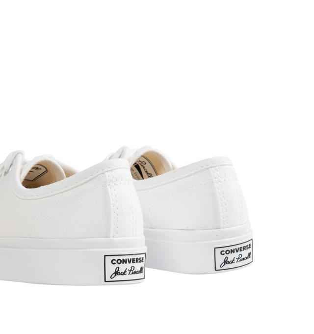 Image 3 of 5 - WHITE - Converse Jack Purcell Sneakers in a refined, sporty low top style. Featuring durable canvas upper, layers of comfort cushioning with a wedge helps provide optimal support, signature smile branding on the toe cap, and rubber sole with herringbone details helps provide traction. Unisex style in men's sizes.