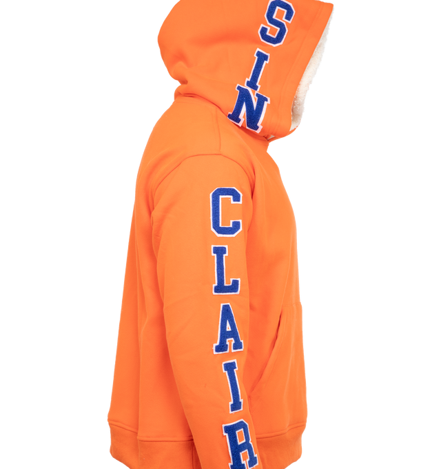 Image 3 of 4 - ORANGE - SINCLAIR GLOBAL AB SPECIAL SWEATSHIRT featuring loose fit, embroidered chenille logo down hood and sleeve, kangaroo pocket and sherpa lining.  