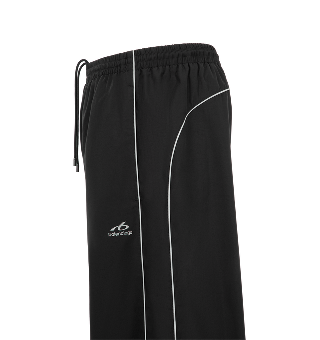 Image 3 of 3 - BLACK - Balenciaga Men's Bodies Tracksuit Pants are crafted from technical cotton poplin and feature a mid-rise silhouette with an elasticated waistband. Reflective piping, two slash pockets, and reflective-effect Bodies artwork printed at the front complete the design. Main Material: 50% Cotton, 50% Polyamide. Lining: 100% Polyester. Made in Italy.