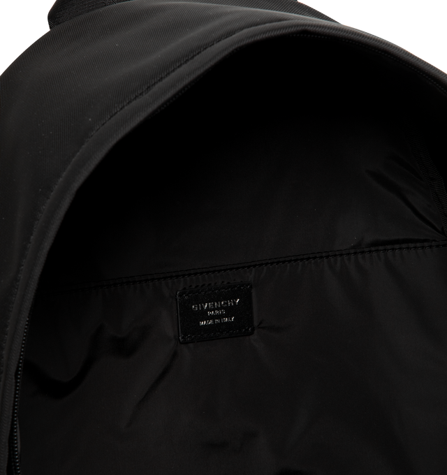 Image 3 of 3 - BLACK - GIVENCHY Essential U Backpack featuring zipper closure with double leather zipper pull, metal GIVENCHY signature on the front, comfortable adjustable padded straps, one zippered pocket on the front and one flat pocket inside. 12.6 in x 16.9 in x 7.9 in. 100% polyamide. Secondary material: 100% calfskin leather. Made in Italy.