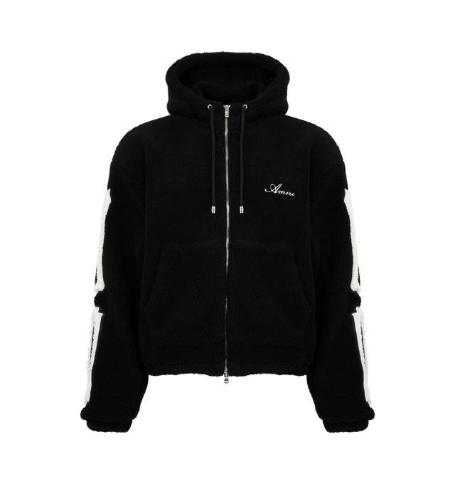 Image 1 of 3 - BLACK - AMIRI Bones Cotton Fleece Zip-Up Hoodie featuring plush cotton fleece, signature contrast bones patchwork along each sleeve, attached drawstring hood, drop shoulders, long sleeves, split kangaroo pocket and two-way front zip closure. 100% cotton. Made in Italy.