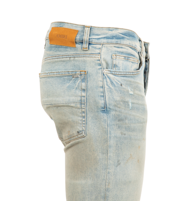 Image 3 of 3 - BLUE - AMIRI Stack Jeans featuring stretch denim, belt loops, five-pocket styling, button-fly, skinny leg, quilted leather patched at front, leather logo patch at back waistband and logo-engraved silver-tone hardware. 92% cotton, 6% elastomultiester, 2% elastane. Made in United States.