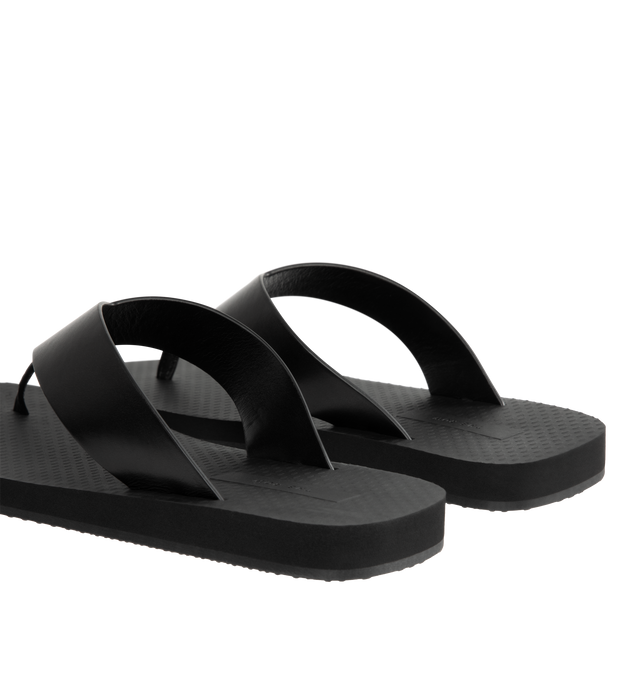 Image 3 of 4 - BLACK - THE ROW Dune Classic Ginza Sandal featuring modern flip flop sandal in sleek calfskin leather with seamless contoured strap, textured footbed, and lightly treaded rubber sole. 100% calfskin leather. Made in Italy.