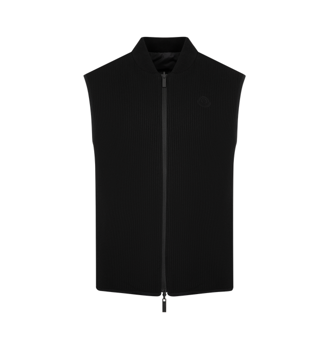 Image 1 of 3 - BLACK - MONCLER Reversible Padded Vest featuring waffle polyester, rib knit bomber collar in cotton, reversible, padded, zipper closure, zipped pockets and silicone logo patch. 100% polyester. Made in Turkey
