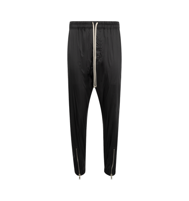 Image 1 of 3 - BLACK - Rick Owens Men's Tecuatl Track Pant crafted from black lightweight, fluid cupro twill. Full-length style with slightly dropped crotch, elasticized waist band with drawstring and stitched fly. Featuring 2 diagonal side front pockets, back welt pockets with snaps and elasticized hems with a zippered slit on the front shin. 100% Cupro, plant-based, biodegradable fabric made using repurposed cotton waste fibers. Buttons made from 100% buffalo horn.