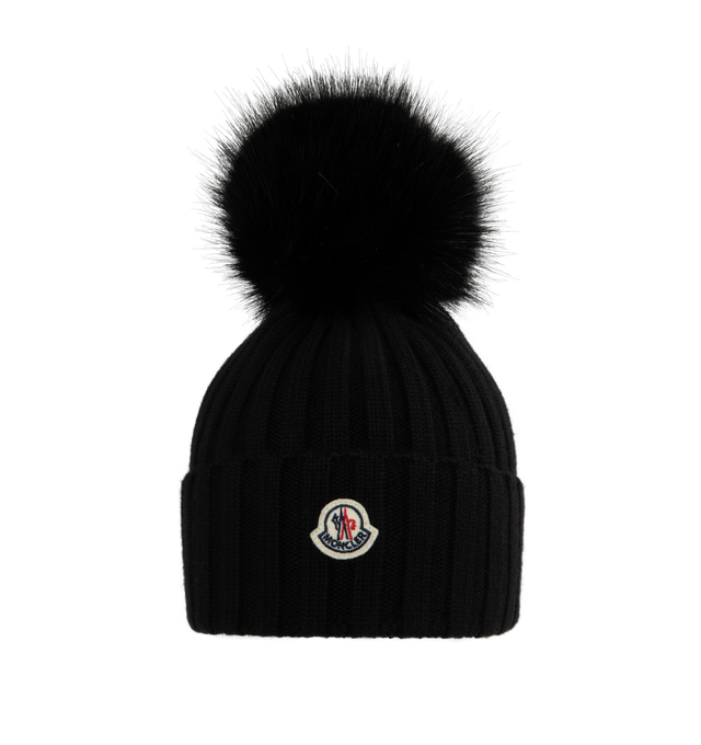 Image 1 of 2 - BLACK - MONCLER Wool Beanie featuring ultra-fine Merino wool, faux fur pom pom, rib knit and Gauge 5. 100% virgin wool. Made in Bulgaria. 