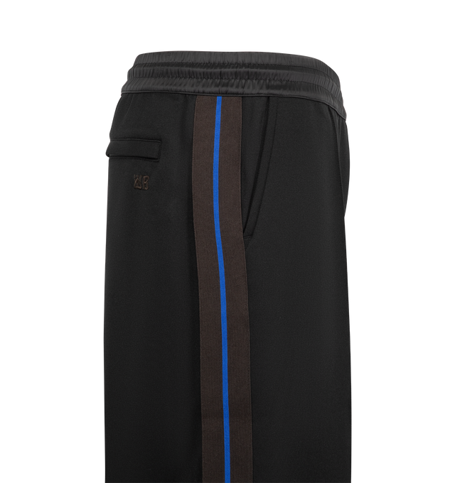 Image 3 of 3 - BLACK - Wales Bonner Men's Form Track Pant is crafted from a stretch cotton-blend piqu fabric and features a straight-leg silhouette with side stripe detailing and piped trim. Designed with an elasticized waistband and concealed drawstring, these track pants are finished with pinched seams at the legs, zip vents at the cuffs, two side welt pockets, and a rear welt pocket with logo embroidery. Main Material: 56% Polyester, 39% Cotton, 5% Elastane. Lining: 100% Organic Cotton. Trim: 100% Viscos