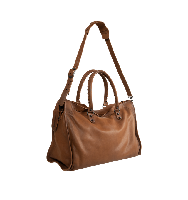 Image 2 of 3 - BROWN - Balenciaga Men's Le City Bag Large is crafted from vintage goatskin and features the house's iconic relaxed silhouette with two hand-braided handles detailed with waxed cord. Designed for hand or crossbody carry, this designer bag features an adjustable and removable shoulder strap with shoulder pad, brass hardware, a double-sided zip closure with long tails and knotted leather puller, front zipped pocket, interior zipped pocket, removable mirror with tone-on-tone Balenciaga logo, and