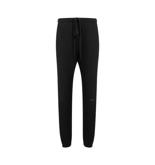 Image 1 of 3 - BLACK - FEAR OF GOD ESSENTIALS Vintage Fleece Sweatpant featuring vintage fit, slimmer leg, "Essentials Fear of God" beveled metallic logo, encased elastic waistband, heavyweight drawstring with rubberized tip, side seam pockets and "Fear of God Essentials" translucent rubberized label. 80% cotton, 20% polyester fleece.
