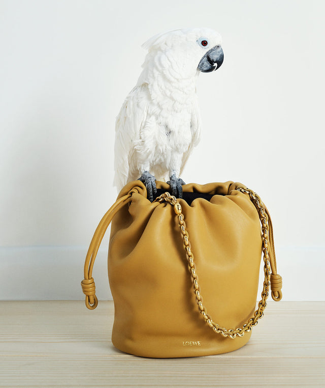 Flamenco bucket purse in tan leather from the Loewe Paula's Ibiza collection with a parrot on top 