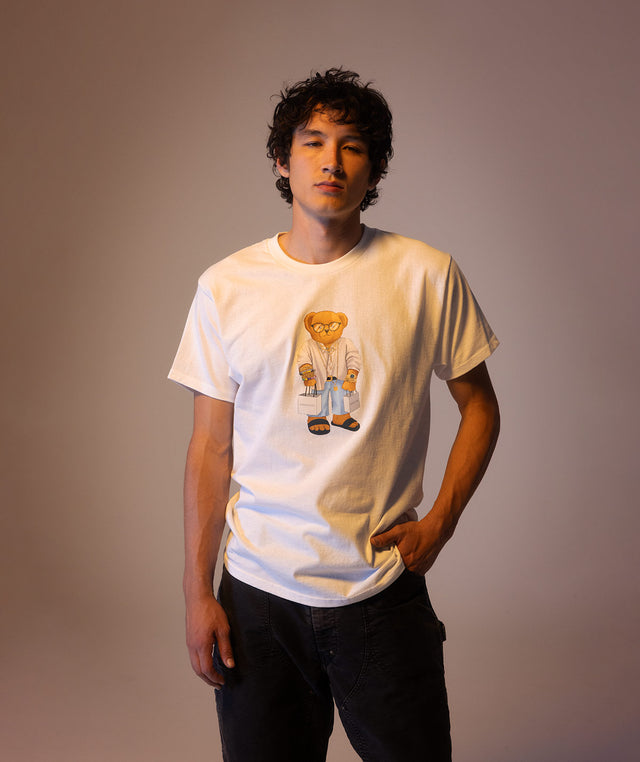 Person wearing a white t-shirt with a Bear graphic design from the Market x Hirshleifers collection