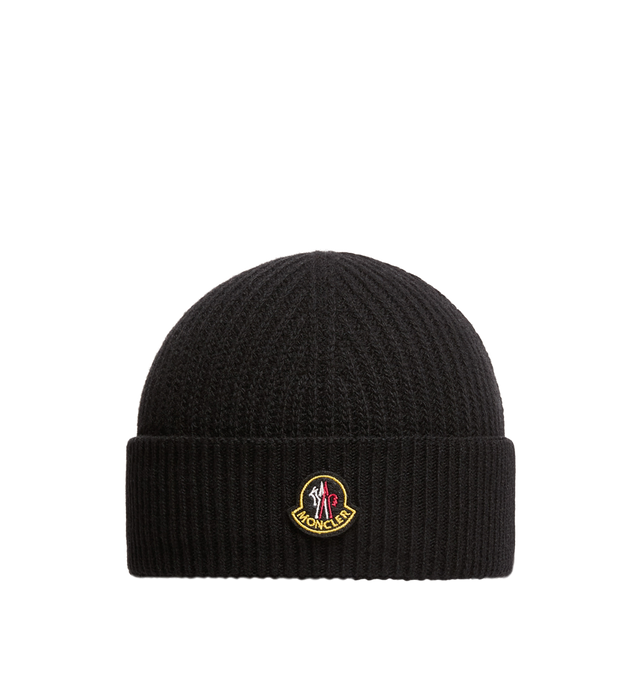 Image 1 of 1 - BLACK - Moncler Men's Wool and Cashmere Beanie is crafted from a luxurious wool and cashmere blend and features a textured half-brioche stitch knit for enhanced softness and dimension. Inspired by Moncler's mountain heritage, this cold-weather accessory is finished with a logo patch reminiscent of vintage alpine pins. Main Material: 90% Virgin Wool, 10% Cashmere.