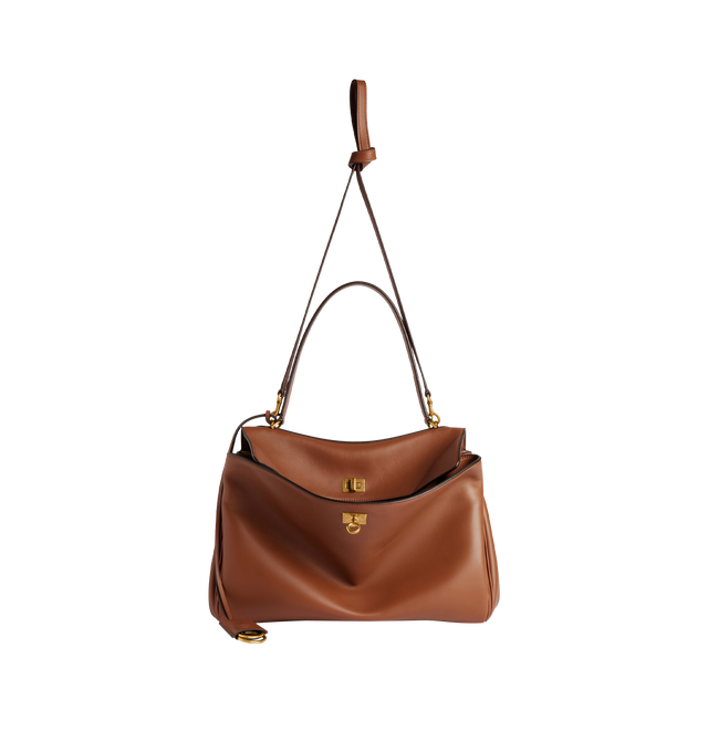 Image 4 of 5 - BROWN - BALENCIAGA Rodeo Top Handle Bag featuring a turn lock closure, a single top handle for hand carrying, an adjustable shoulder strap, side snaps, brass feet, a removable leather keychain holder, a wide front pocket and an interior zipper pocket. 13.8 X 9.2 X 4.3 inches. 100% calfskin. Made in Italy.