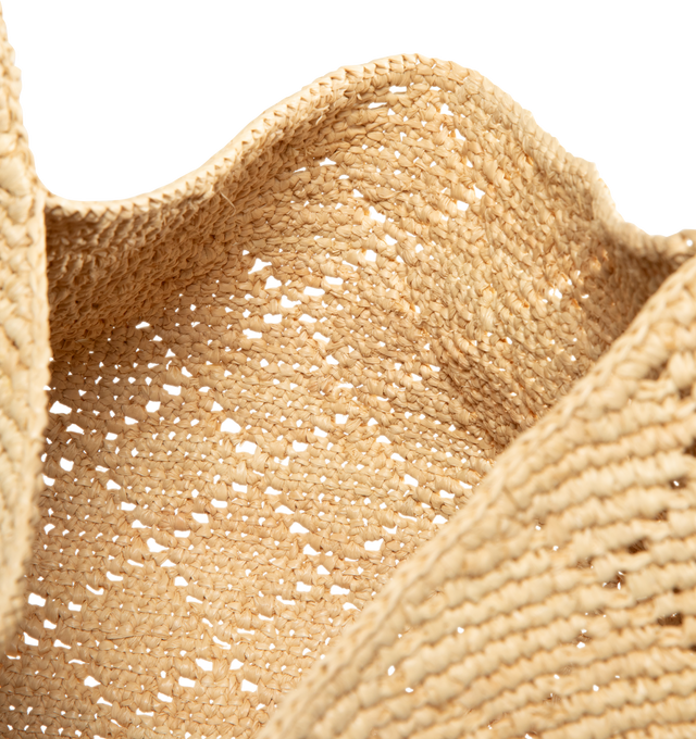Image 3 of 3 - NEUTRAL - Saint Laurent hobo version of the iconic ICARE, in diamond-crocheted raffia and vegetable-tanned leather. This modern, spacious bag allows for multiple carry options. Featuring leather lining, bronze-tone hardware, zip closure. Measures 11.818.5" x 12.0" x 0.84.7" with 6.3" handle drop. Made in Madagascar.