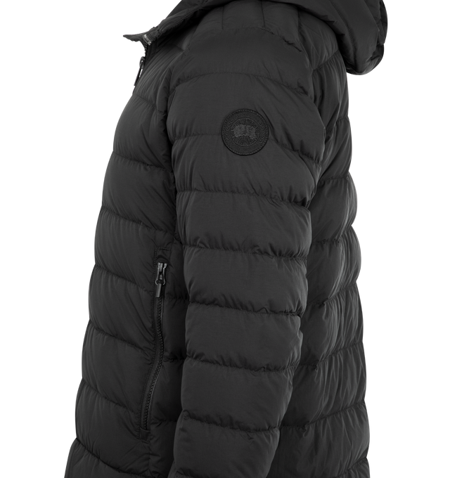 Image 3 of 3 - BLACK - CANADA GOOSE Crofton Hoodie EnduraLuxe Jacket featuring two-way zipper, packable into interior left pocket, converts into a cinchable bag with a carrying strap, adjustable hood with hidden drawcord, removable interior backpack straps for hands-free carrying capabilities, interior drawcord at hem, wo exterior tricot-lined zippered hand pockets and one interior drop-in pocket. 100% recycled polyamide. Made in Canada.