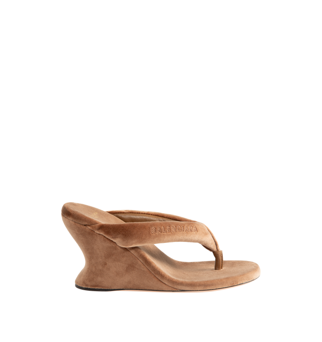 Image 1 of 4 - BROWN - Balenciaga Womens Gaeta Wedge Thong Sandals are crafted from a plush stretch velvet material. Feature a round toe, padded thong strap, slip-on design, 90mm arch wedge heel, and leather sole. Upper: cotton, viscose, elastane, Sole: calfskin, Insole: cotton, viscose, elastane. Made in Italy.