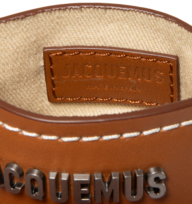 Image 3 of 3 - BROWN - JACQUEMUS Le porte carte Meunier featuring logo plaque at face, two card slots at back face, cotton twill lining and contrast stitching. H3 x W4.5 in. 100% leather. Made in Spain. 