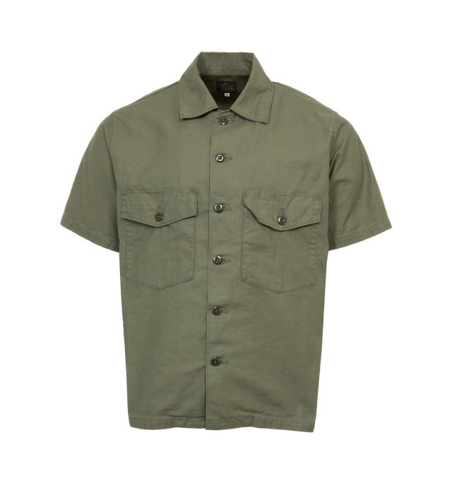 Image 1 of 3 - GREEN - NEEDLES Fatigue Shirt featuring short sleeves, collar, front flap pockets and button closure. 100% cotton. Made in Japan. 