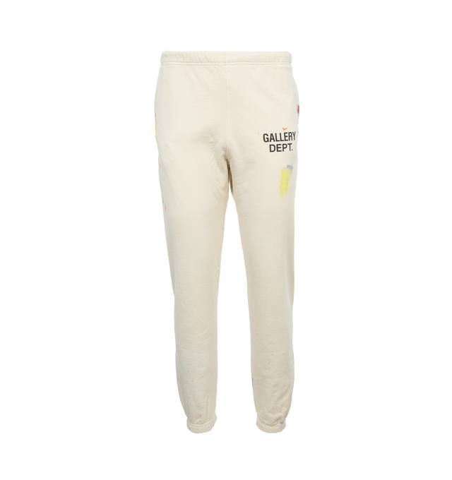 Image 1 of 4 - WHITE - GALLERY DEPT. LOGO SWEATPANTS featuring tapered leg, low-crotch style, elasticated at the waist and hem, paint splatter and logo on leg. 100% cotton. 